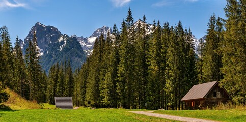 Fototapeta na wymiar Peaceful morning scene of mountain valley with wooden cabin and spruce forest in High Tatras National Park, Slovakia, Europe. Beauty of nature concept background. Slovakia, Europe. Beauty world.