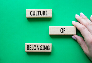 Culture of Belonging symbol. Wooden blocks with words Culture of Belonging. Beautiful green background. Business and Culture of Belonging concept. Copy space.