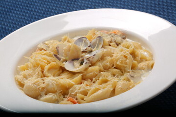 Orecchiette pasta with clam, creamy sauce and dill. Healthy food. on restaurant table 