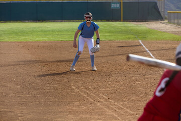 Young female Softball player playing youth sports.