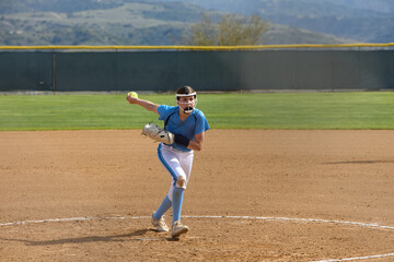 Young female Softball player playing youth sports. Pitcher
