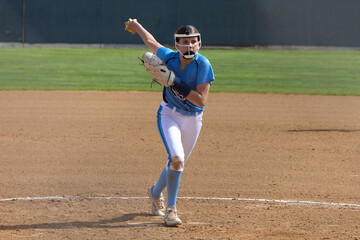 Young female Softball player playing youth sports. Pitcher