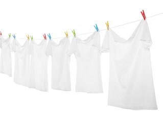 Many t-shirts drying on washing line isolated on white