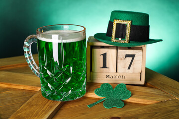 St. Patrick's day celebrating on March 17. Green beer, block calendar, leprechaun hat and...