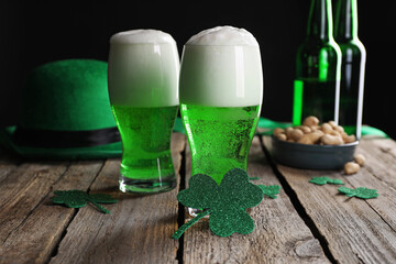 St. Patrick's day party. Green beer, decorative clover leaves, leprechaun hat and nuts on wooden...