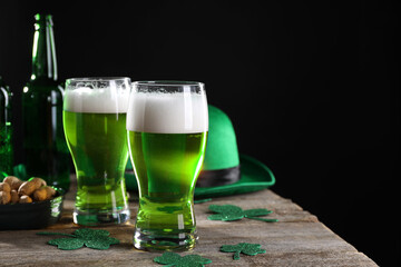 St. Patrick's day party. Green beer, nuts, leprechaun hat and decorative clover leaves on wooden...