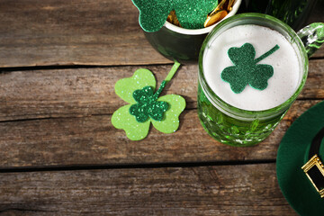 St. Patrick's day party. Green beer, leprechaun hat, pot of gold and decorative clover leaves on...