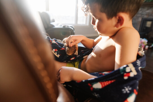 Boy caressing his pet with affection. 