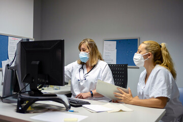 Physicians reviewing a medical record