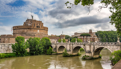 A shot of Castel Sant'Angelo in Rome from across the Tiber river - obrazy, fototapety, plakaty