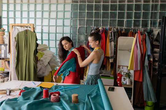 seamstress measures approximate size of client