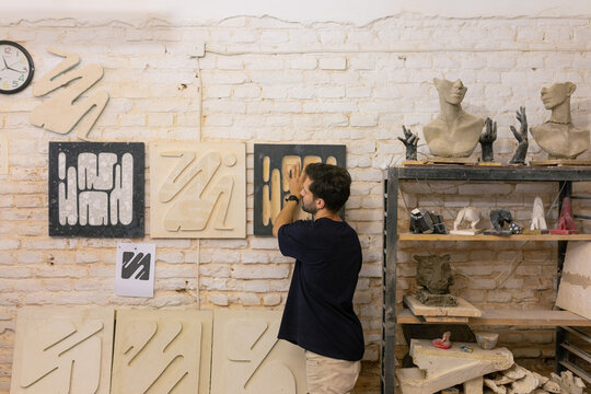 sculptor hangs work