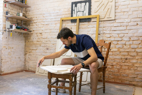 sculptor working with clay