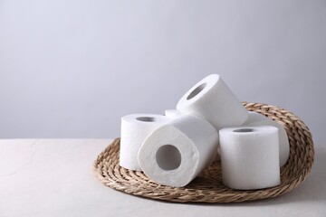 Toilet paper rolls on white table, space for text