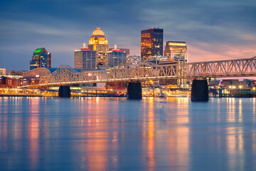 Louisville, Kentucky, USA. Cityscape image of Louisville, Kentucky, USA downtown skyline with reflection of the city the Ohio River at spring sunset.