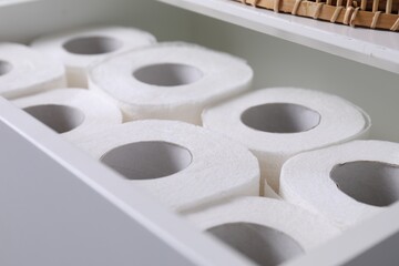 Many toilet paper rolls in white drawer indoors, closeup - obrazy, fototapety, plakaty