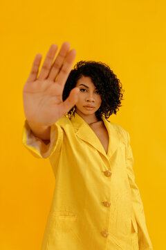 Black woman showing stop gesture in studio