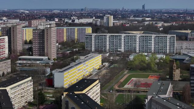 Flying past high-rise buildings and apartment blocks in the Gr&uuml;nau district of Leipzig. The telephoto shot condenses the buildings in the district. The city center of Leipzig in the background.