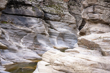 Tasyaran canyon, which attracts attention with its rock shapes similar to Antelope canyon in Arizona, offers a magnificent view to its visitors. Canyon view and stream at sunset. Usak, Turkey.