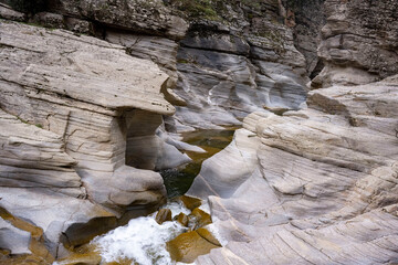 Tasyaran canyon, which attracts attention with its rock shapes similar to Antelope canyon in Arizona, offers a magnificent view to its visitors. Canyon view and stream at sunset. Usak, Turkey.