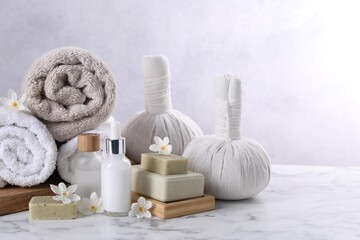 Composition with spa supplies and flowers on white marble table