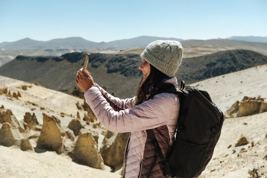 Traveller capturing picture of beautiful landscape with phone