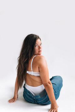 Woman Wearing Bra and Jeans