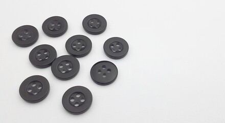 Black sewing buttons isolated on white background. Copy space for text.