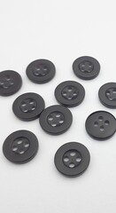 Black sewing buttons isolated on white background. Copy space for text.