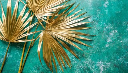 three gold painted date palm leaves on desaturated turquoise background