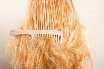 Comb tangled in long blonde hair 
