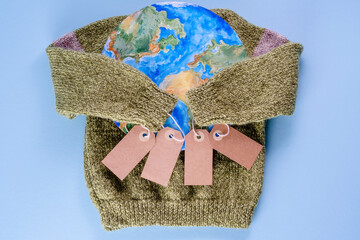 Creative concept buy less and overconsumption. The sweater sleeves holding the tags in the embrace...