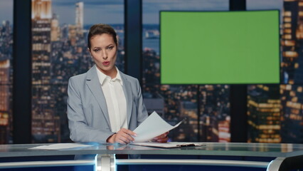 Presenter showing mockup screen reporting breaking news in tv channel studio