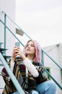 A young woman is using a smartphone