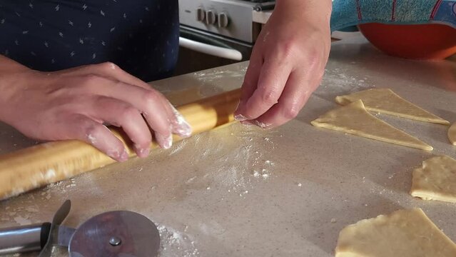 
Process of preparing ham and cheese croissants called "cachitos" in Venezuela