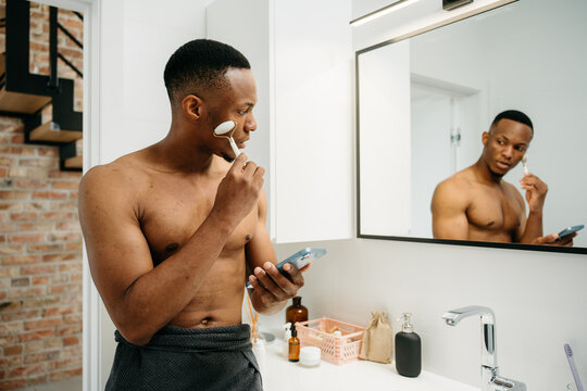 A man does a facial massage
