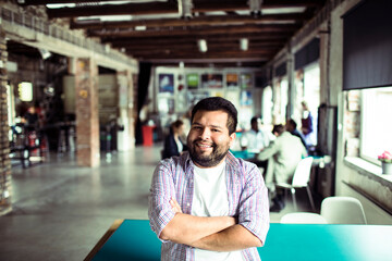 Portrait of a confident young man smiling in startup office