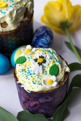 Top view of apetite Easter pastries. Easter cake, eggs and spring flowers