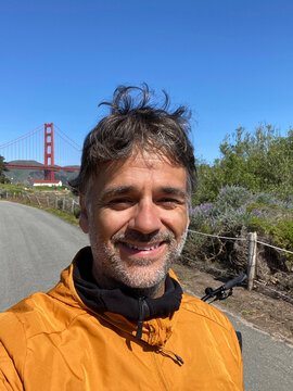 Tourist man taking a selfie with Golden Gate Bridge