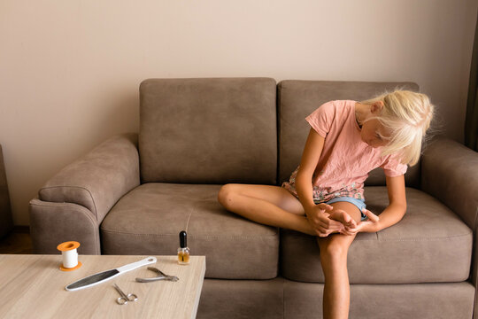 Little girl examine her foot