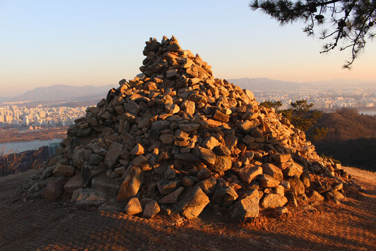 A pile of stones on the mountain at sunset