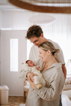 young parents with their newborn at home