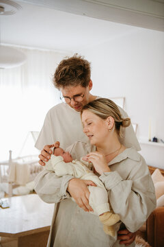 young parents with their newborn at home