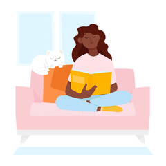 Dark-skinned young woman sitting on the sofa and reading a book