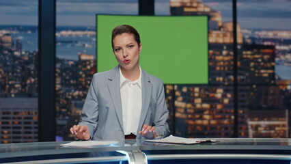Female newscaster reporting chromakey news at studio closeup. Presenter talking