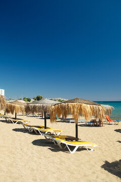 Empty long beach with parasols, Rhodes, Greece