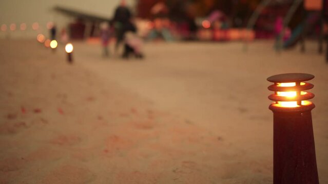 Lighted lantern on background of people walking