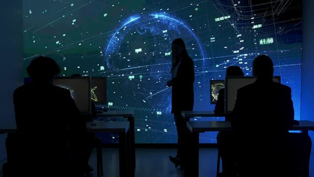 Technical support team in control room. IT specialists at the security office, big digital screen shows surveillance monitoring infographic global network.