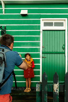 Little  girl against green facade 