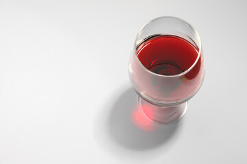 Tasty red wine in glass isolated on white, above view